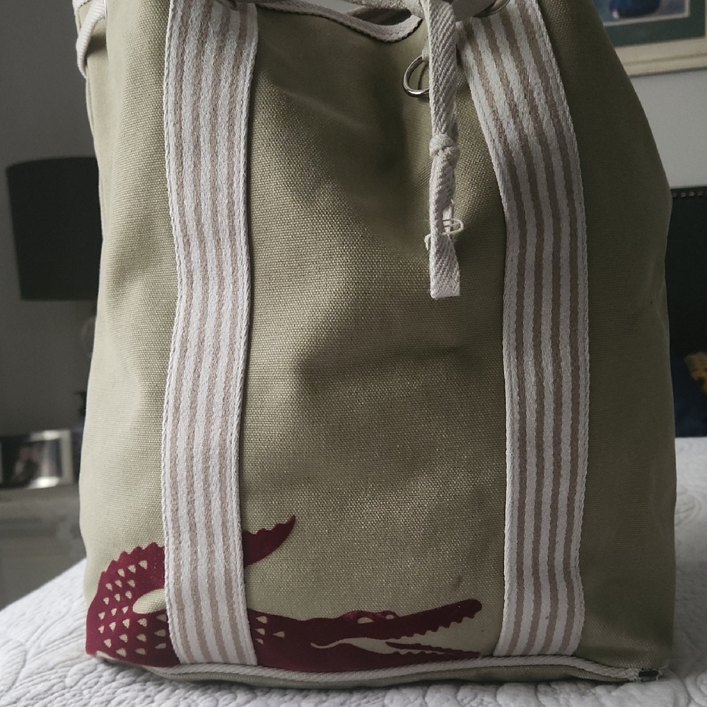 Lacoste Tan and White Travel Bag with Sturdy Design